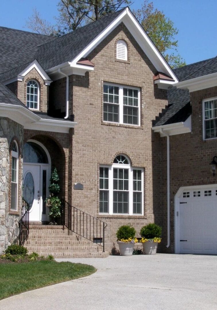 A large brick house with two garage doors.
