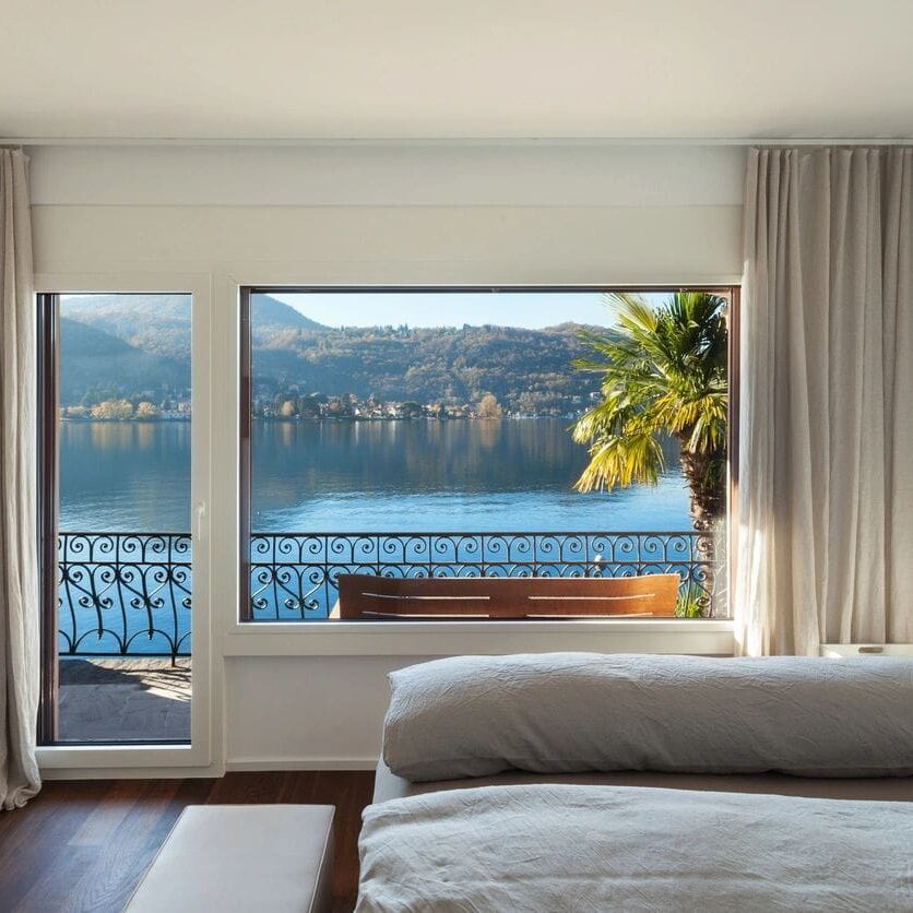 Nice bedroom with large window, view of the lake